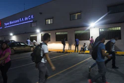 Workers gather outside a 'maquiladora' for car accessories in Matamoros, Mexico, March 21, 2017.