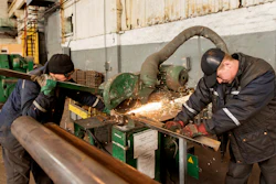 Two workers weld metal inside the Interpipe Steel plant in Dnipro, Ukraine, Thursday, March 10, 2022.