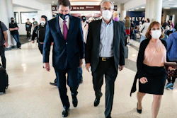 Sen. Bill Hagerty, R-Tenn., left, walks with Greg Kelly, center, and his wife, Dee Kelly, Nashville International Airport, March 14, 2022.