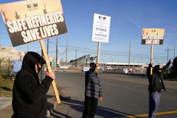 Operators holds up picket signs and acknowledge honking horns outside the Chevron Corp. refinery on March 21, 2022, in Richmond, Calif.