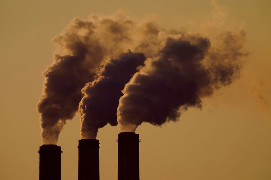 Emissions rise from the smokestacks at the Jeffrey Energy Center coal power plant as the suns sets, near Emmett, Kan., Sept. 18, 2021. The Environmental Protection Agency is proposing a federal plan that would restrict smokestack emissions from power plants and other industrial sources that burden downwind areas with air pollution they can't control.