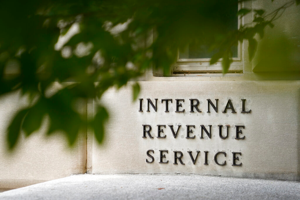 This May 4, 2021 file photo shows the outside of the Internal Revenue Service building in Washington. Small businesses that have been buffeted by the pandemic, inflation and shipping woes have another challenge to add to their plate: taxes. Tax season can be complicated for everyone, but as the April 18 filing deadline looms, small business owners, contractors, entrepreneurs and others face even more rules and regulations that are ever-changing. The Internal Revenue Service has announced a backlog and warned that more delays are to be expected. The IRS said earlier this month it was hiring 10,000 workers to deal with a backlog of 23 million items triggered by limiting operations during the coronavirus pandemic.