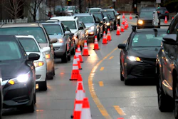 Cars line up early morning along Green Bay Road waiting to receive free gas donated by Willie Wilson at the Mobil Gas Station on Thursday, March 24, 2022, in Evanston, Ill.