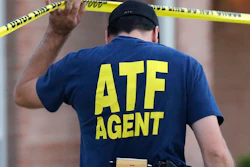 An ATF agent lifts crime scene tape, DeSoto, Texas, Aug. 8, 2013.