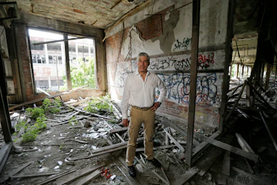 In this June 27, 2014, photo, Packard Plant owner Fernando Palazuelo stands in his proposed future office at the industrial site in Detroit. A judge has deemed the deteriorating Packard plant on Detroit's east side a public nuisance and ordered its Peruvian owner to tear the former auto factory down. Wayne County Circuit Court Judge Brian Sullivan wrote in a March 31, 2022, order that Palazuelo and his Arte Express Detroit must remove all rubbish and debris from the sprawling site that covers several city blocks and demolish all buildings and structures on the property.