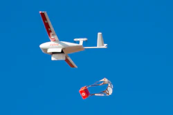 In this photo provided by Zipline, a drone makes a package drop during a demonstration at Zipline's Northern California hub in 2021. Zipline, an American company that specializes in using autonomously flying drones to deliver medical supplies, has taken off in Japan.
