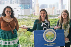 Florida Commissioner of Agriculture and Consumer Services Nikki Fried, center, speaks during a news conference along with youth climate leaders, Valholly Frank, left, and Delaney Reynolds, right, Thursday, April 21, 2022, at the Phillip & Patricia Frost Museum of Science in Miami. Fried unveil a proposed rule to require that utilities operating in the state generate 100% of their electricity from renewable sources of energy by 2050.