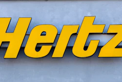 In this Nov. 28, 2017 photo a Hertz rental car logo rests on the front of a Hertz location, in Boston. Hertz is planning to buy up to 65,000 electric vehicles from Swedish premium electric car maker Polestar over the next five years as it looks to boost its electric vehicle rental fleet. Financial terms were not disclosed. The vehicles are expected to be available in Europe in the spring and in North America and Australia later this year. The announcement on Monday, April 4, 2022 comes more than five months after Hertz said that it will buy 100,000 electric vehicles from Tesla.