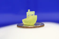 A boat figurine produced by a new 3D printing process that makes it possible to print an object within a volume of resin –like an action figure floating in the center of a block of Jell-O–rather than having to build the object layer by layer.