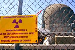 A sign warning of radioactive materials is seen on a fence around a nuclear reactor containment building on Monday, April 26, 2021, a few days before it stopped generating electricity at Indian Point Energy Center in Buchanan, N.Y. The Biden administration is launching a $6 billion effort to save nuclear power plants at risk of closing, citing the need to continue nuclear energy as a carbon-free source of power that helps to combat climate change.