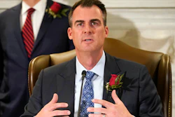 Oklahoma Gov. Kevin Stitt speaks at a signing ceremony to sign into law a bill, Tuesday, April 12, 2022, in Oklahoma City. The governor is asking lawmakers to approve a massive package of financial incentives to help lure an unnamed company to the state. Stitt made the request at a news conference on Monday, April 18. He told reporters he was prohibited from naming the company or the total cost of the package.