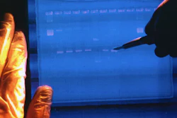 A National Human Genome Research Institute researcher examines the output from a DNA sequencer.