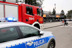 A police car and a firefighters' truck before the Pniowek coal mine in Pawlowice, southern Poland, on Wednesday, April 20, 2022, where two underground methane explosions killed five people and injured more than 20 early Wednesday.