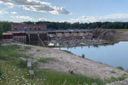 Debris rests at the spillway of the Sanford Dam in downtown Sanford, Mich., Thursday, July 30, 2020. The failure of two Michigan dams that forced evacuation of 10,000 people and destroyed 150 homes was “foreseeable and preventable,” resulting from errors and miscalculations over nearly a century, an expert panel said Wednesday, May 4, 2022.