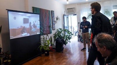 Amazon Labor Union lead organizer Mat Cusick, second from right, standing, watches a zoom-cast of vote counting to unionize an Amazon warehouse in Staten Island, N.Y., March 31, 2022.