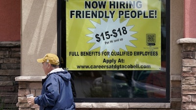 Starting wages advertised in the window of a Taco Bell in Sacramento, Calif., May 9, 2022.