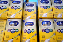Infant formula is stacked on a table during a baby formula drive to help with the shortage May 14, 2022, in Houston. President Joe Biden has invoked the Defense Production Act to speed production of infant formula and has authorized flights to import supply from overseas.