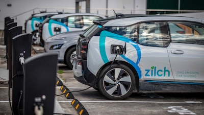 Electric vehicle charging station and car share parking are seen in Auckland, New Zealand, on Aug. 12, 2021. New Zealand will help pay for lower-income families to scrap their old gas guzzlers and replace them with cleaner hybrid or electric cars as part of a sweeping plan to reduce greenhouse gas emissions the government announced Monday May 16, 2022.