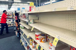 An employee walks near empty shelves where baby formula would normally be located at a CVS in New Orleans on Monday, May 16, 2022. President Joe Biden's administration has announced new steps to ease the national shortage of baby formula, including allowing more imports from overseas.