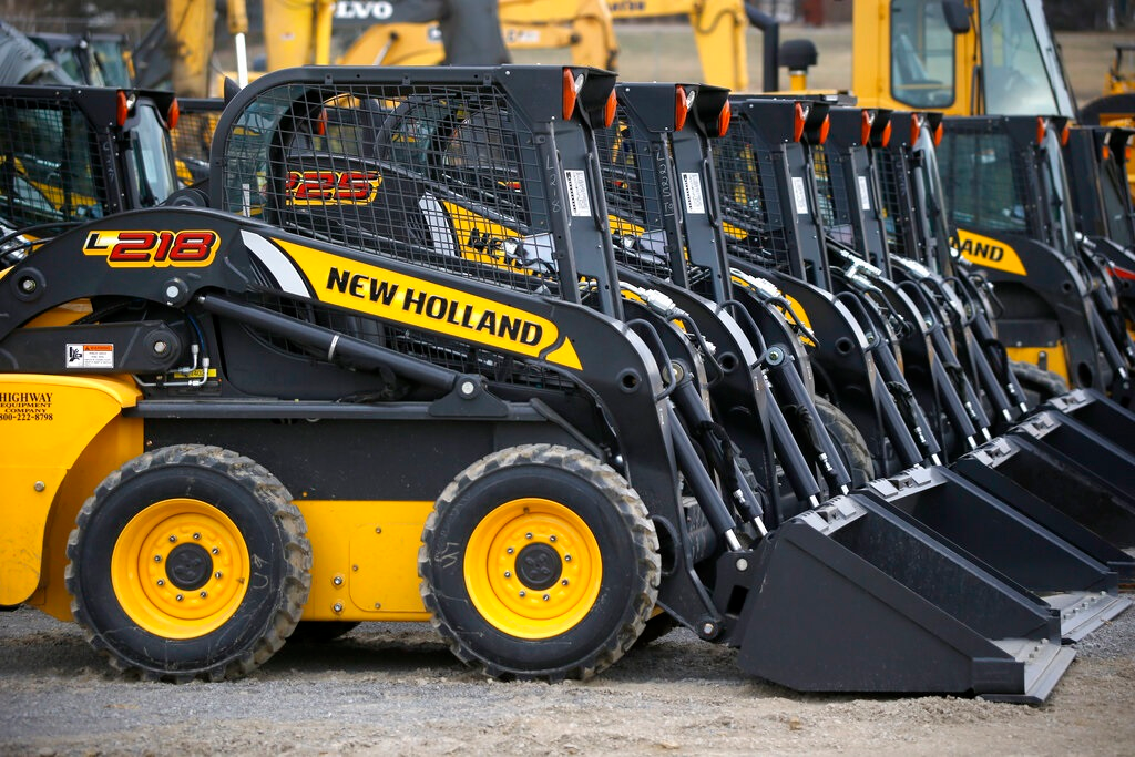In this photo made on Friday, March 28, 2014, earth moving and construction equipment by New Holland, a CNH Industrial brand, is stored on a lot at the Highway Equipment Company in Zelienople, Pa. More than 1,000 workers at CNH Industrial plants in Wisconsin and Iowa went on strike Monday, May 2, 2022, in search of a better deal with the company that makes agriculture and construction equipment.