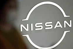 A visitor walks near a Nissan logo at Nissan headquarters on May 12, 2022, in Yokohama near Tokyo. Nissan is considering adding a new auto plant in the U.S. to keep up with growing demand for electric vehicles, a top executive at the Japanese automaker said Friday, May 13, 2022.