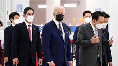US President Joe Biden, cente, South Kroean President Yoon Suk-youl, right and Samsung Electronics Co. Vice Chairman Lee Jae-yong, second left, walk at the Samsung Electronic Pyeongtaek Campus, in Pyeongtaek, South Korea, Friday. May 20, 2022.