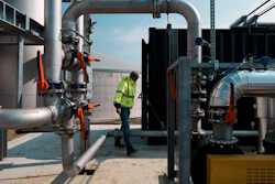 A worker walks among pipelines that will carry gas toward Rambouillet, France, May 3, 2022.