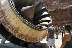 Tourists look at an old turbine that was replaced at the Glen Canyon Dam.