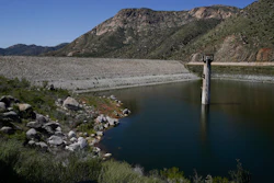 The dam at El Capitan Reservoir is seen Friday, April 8, 2022, in Lakeside, Calif. Constructed four generations ago, the massive rock and clay dam is capable of storing over 36 billion gallons of water — enough to supply every resident in San Diego for most of a year. Today, it's three-quarters empty — intentionally kept low because of concerns it could fail under the strain of too much water.