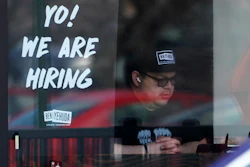 A hiring sign is displayed at a restaurant in Schaumburg, Ill., April 1, 2022.