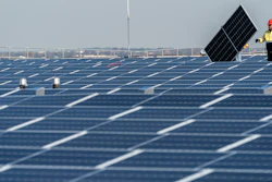 Electricians with IBEW Local 3 install solar panels on top of the Terminal B garage at LaGuardia Airport, Nov. 9, 2021, in the Queens borough of New York. President Joe Biden plans to invoke the Defense Production Act to increase U.S. manufacturing of solar panels while declaring a two-year tariff exemption on panels from Southeast Asia.
