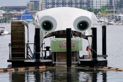 Mr. Trash Wheel, a mechanism that collects trash from tributaries that feed into Baltimore's Inner Harbor sits in the water, Friday, May 13, 2022, in Baltimore. Many novel devices are being used or tested worldwide to trap plastic trash in rivers and smaller streams before it can get into the ocean. Officials say Mr. Trash Wheel has inspired fans to begin recycling or join trash cleanups.