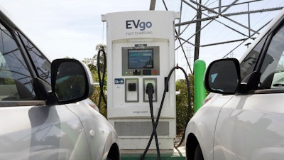 Electric cars are parked at a charging station in Sacramento, Calif., Wednesday, April 13, 2022. California air regulators will take public comment Thursday, June 23 2022, on a plan to slash fossil fuel use and reach carbon neutrality by 2045.