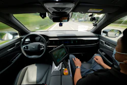 A technician monitors the self-driving taxi developed by tech giant Baidu Inc. on June 14, 2022, in Beijing. Baidu Inc. is China's highest-profile competitor in a multibillion-dollar race with Alphabet Inc.'s Waymo and General Motors Co.'s Cruise to create self-driving cars.