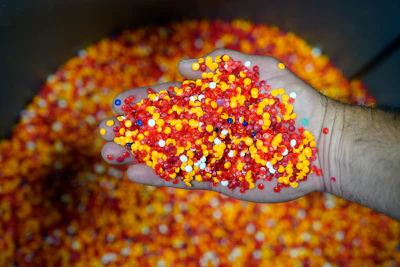 A mix of colored vinyl pellets that will be made into records is stored in a bin at the United Record Pressing facility Thursday, June 23, 2022, in Nashville, Tenn. Colored pellets are used by themselves or in a variety of combinations to create colorful records in addition to the traditional black vinyl.