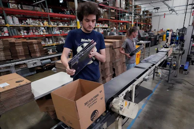 Elijah Lindsay loads finished vinyl records into shipping boxes at the United Record Pressing facility Thursday, June 23, 2022, in Nashville, Tenn. Vinyl record manufacturers are rapidly rebuilding an industry to keep pace with sales that topped $1 billion last year.