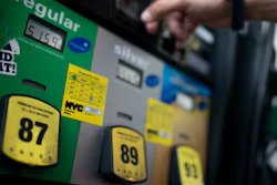 Wallace Reid purchases fuel for the vehicle he drives to make a living using ride-share apps, Wednesday, June 22, 2022, in the Queens borough of New York.