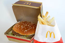 A McDonald's Big Mac, left, rests in a box next to a bag of McDonald's fries, in Walpole, Mass., Wednesday, April 20, 2022. Environmental and health groups are pushing dozens of fast food companies, supermarkets chains and other retail outlets to remove PFAS from their packaging.