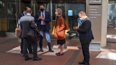 Former Theranos executive Ramesh 'Sunny' Balwani, right, stands near his legal team outside Robert F. Peckham U.S. Courthouse in San Jose, Calif., on March 1, 2022. A jury on Tuesday, June 21 is scheduled to hear closing arguments in the trial of Balwani, the former Theranos officer charged with teaming up with his secret lover, CEO Elizabeth Holmes, to carry out a massive fraud.