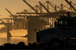 A truck arrives to pick up a shipping container near vessels moored at Maersk APM Terminals Pacific at the Port of Los Angeles, Nov. 30, 2021.