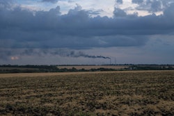 Grain fields backdropped by a power plant in the Donetsk region, Ukraine, July 22, 2022.
