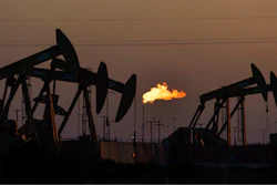 A flare burns off methane and other hydrocarbons as oil pumpjacks operate in the Permian Basin in Midland, Texas, Tuesday, Oct. 12, 2021. Massive amounts of methane are venting into the atmosphere from oil and gas operations across the Permian Basin, new aerial surveys show. The emission endanger U.S. targets for curbing climate change.