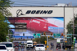 Traffic drives in view of a Boeing Co. production plant, where images of jets decorate the hangar doors on April 23, 2021, in Everett, Wash. Roughly 2,500 Boeing workers are expected to go on strike the following month at three plants in the St. Louis area after they voted Sunday, July 24, 2022, to reject a contract offer from the plane maker.