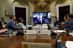 President Joe Biden, on screen at center, participates in a meeting with SK Group Chairman Chey Tae-won, fourth from right, from the Roosevelt Room of the White House in Washington, Tuesday, July 26, 2022. The meeting comes as the Biden administration is seeking the cooperation of Asian allies such as South Korea to reinforce supply chains for critical components such as semiconductors.