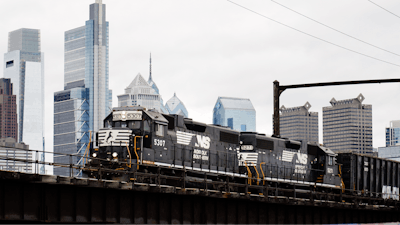 A Norfolk Southern freight train moves along elevated tracks in Philadelphia, Oct. 27, 2021.