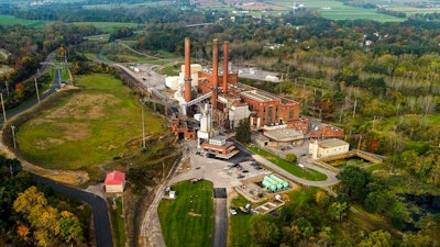 A brief patch of early morning sunlight brightens the landscape around the Greenidge Generation power plant, Oct. 15, 2021, in Dresden, N.Y. State officials on Thursday, June, 30, 2022, denied air permit renewals to a bitcoin-mining power plant in Finger Lakes that environmentalists called a threat to New York's climate goals.