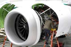 A Boeing employee works on the engine of a 737 MAX on the final assembly line at Boeing's Renton plant, June 15, 2022 in Renton, Wash. Delta is ordering 100 of Boeing's 737 Max 10 airplanes, with an option to purchase 30 more, as the airline looks to keep up with surging travel demand. Delta Air Lines said Monday, July 18, 2022 that the airplanes, which can seat up to 230 people, will reduce fuel use and emissions by 20-30% compared to those it replaces.