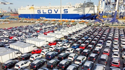 Cars and trucks for export are parked at a port in Yantai in eastern China's Shandong Province, Tuesday, Jan. 4, 2022. China’s monthly trade surplus soared to a record $97.9 billion in June as export growth accelerated following the easing of anti-virus controls that temporarily shut down Shanghai and disrupted trade.