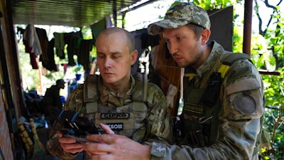 Ukrainian servicemen correcting artillery fire by drone at the frontline near Kharkiv, Ukraine, on Saturday, July 2, 2022. Never in the history of warfare have drones been used as intensively as in Ukraine, where they often play an outsized role in who lives and dies. Russians and Ukrainians alike depend heavily on unmanned aerial vehicles to pinpoint enemy positions and guide their hellish artillery strikes.