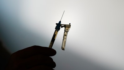 A syringe is prepared at a clinic in Norristown, Pa., Dec. 7, 2021. The Environmental Protection Agency is warning residents in 13 states and Puerto Rico about potential health risks from emissions of ethylene oxide, a chemical widely used to sterilize medical equipment and decontaminate spices.
